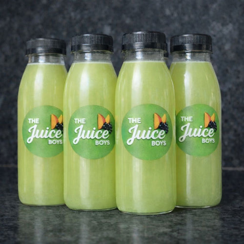 Four bottles of green juice from 'The Juice Boys' on a dark background